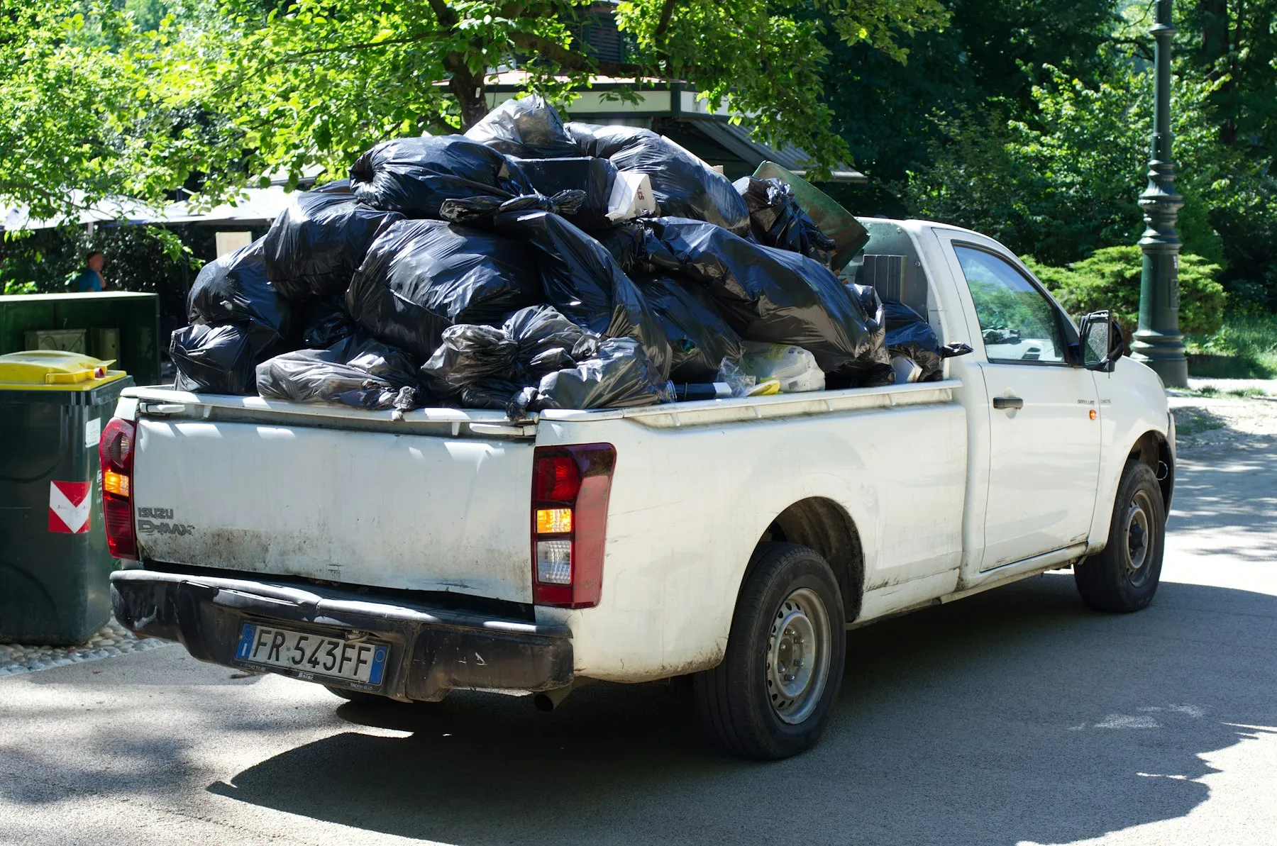 Pickup truck loaded full of bagged junk ready to be hauled away
